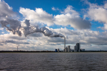 Power station with smoking chimney. Electric plant, turbine generator in the power plant
