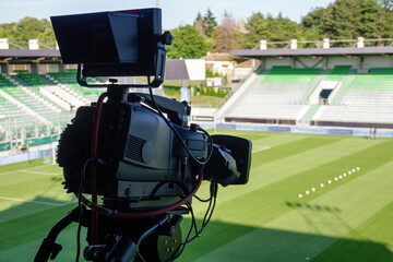 TV camera at the stadium, broadcasting during a football, soccer match