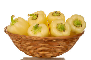 Several ripe sweet peppers in a basket, macro, isolated on white background.