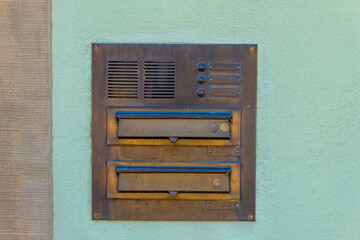 old mailbox with two compartments on a wall