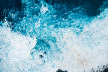 Aerial view of rough ocean with waves and volcanic beach, porto Moniz Madeira, Portugal