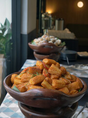 fried cassava cheese in a clay wadh on the table.