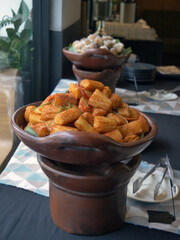 fried cassava cheese in a clay wadh on the table.