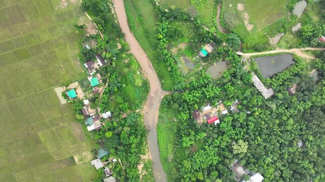 Captivating top down Aerial Shot of Countryside peaceful Green Fields and small River