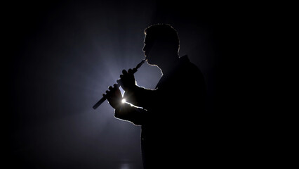 Silhouette of a man in classic suit against a backlight. A sophisticated and elegant image ideal for highlighting professionalism, formal events, and stylish fashion.