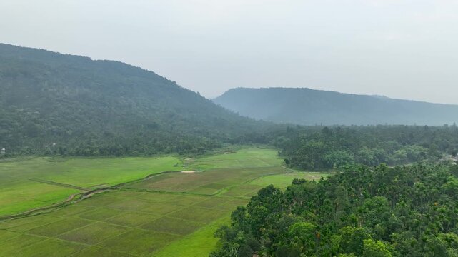 Scenic Mountain Valley with Rolling Hills and Vibrant Fields Aerial view
