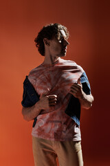 A handsome man expresses deep emotions while posing dramatically.