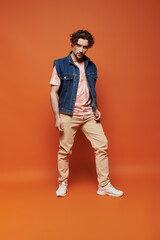 Fototapeta premium A stylish man expresses emotions with a vibrant backdrop enhancing his presence.