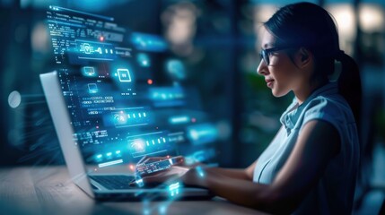 A woman is sitting at a desk and typing on a laptop. The laptop screen is filled with blue and white graphics, giving the impression of a computer game or a digital art piece