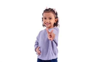A smiling little Asian girl in casual outfit showing two fingers or victory sign, on a white background