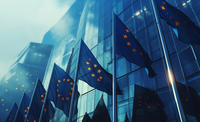 European Union flags flutter in the wind against a modern glass building, symbolizing unity and politics.