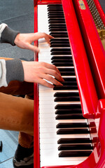 hands of a person playing the piano at Amsterdam airport