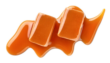 Two sweet caramel candies topped with caramel sauce on white background
