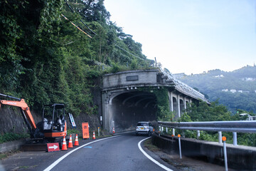 Fototapeta premium Curving Road Leading to a Mountain Tunnel Entrance