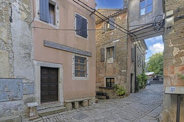 a large brick courtyard leading to two apartment buildings in an old town