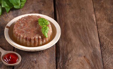 aspic meat appetizer with sauce and basil