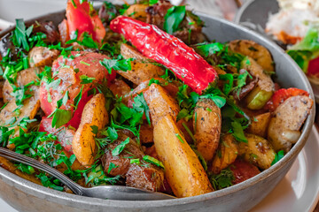 meat stew with potatoes and herbs, selective focus
