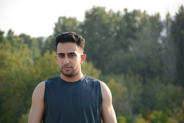 an athletic man looking forward and standing