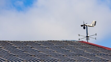 Weather vane, cardinal directions above the roof.