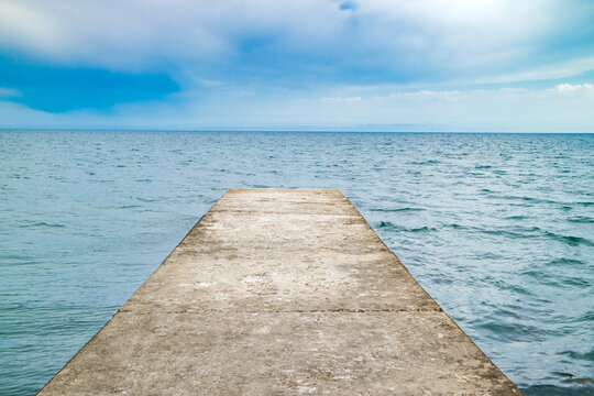 Fototapeta concrete pier extending into the sea