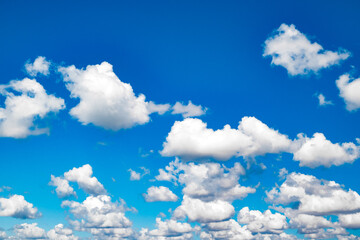 blue sky with white cumulus clouds on clear day