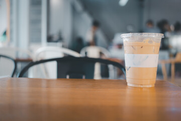 Iced latte coffee in plastic takeaway glass, refreshing look of the drink