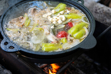 Cast iron cauldron on fire, the concept of cooking delicious food over an open fire.
