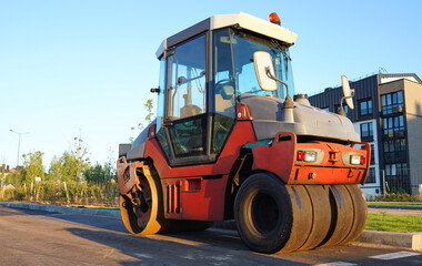 Steamroller, Vibration roller compactor on press asphalt road. Steam Roller, Road Construction Equipment on construction. Asphalt road roller on road construction. Vibration roller at asphalt pavement
