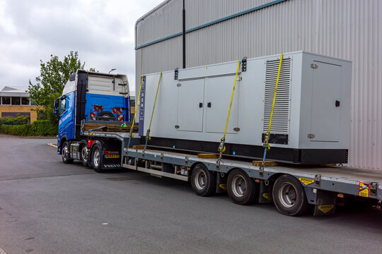 Trafford Park Manchester UK. Heavy industrial equipment being transported on a flatbed truck.