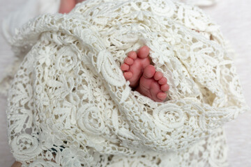 little fingers, newborn feet wrapped in cloth