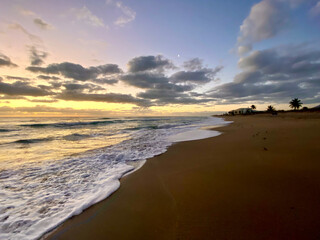 sunrise at beach with clouds and sand