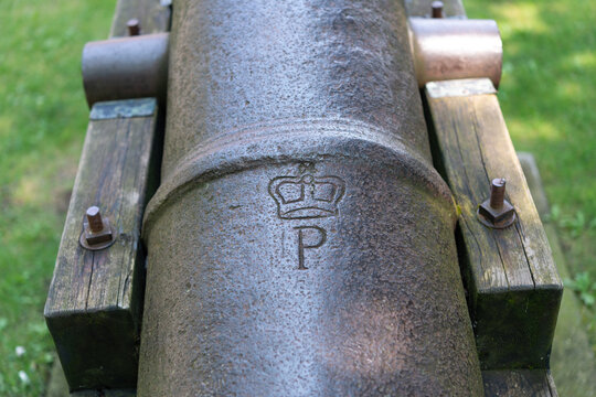 old cannon with crown and the letter P appearing below the trunnion area on the grounds of  Old Mill (site of Toronto's first sawmill built c1793)