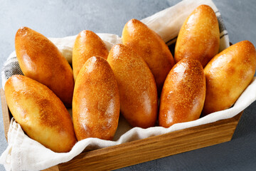 Freshly baked patties ( russian piroshki ) with egg and green onion stuffing.