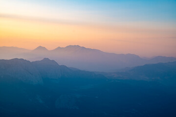 Silhouettes of mountains in a beautiful gentle haze, mountains at sunset or sunrise, natural background