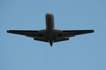 Airplane in the blue sky. Airplane in the sky. Airplane in flight over the blue sky. Traveling concept.