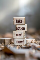 Set wooden blocks meticulously arranged to spell out "Take action now!" against a neutral backdrop