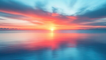 A hazy and blurry picture depicting a beautiful sunset over a calm body of water nearby