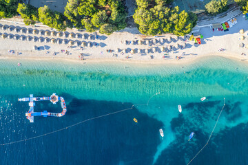 Drone view of the wonderful beach with azure water in Primosten, Croatia.