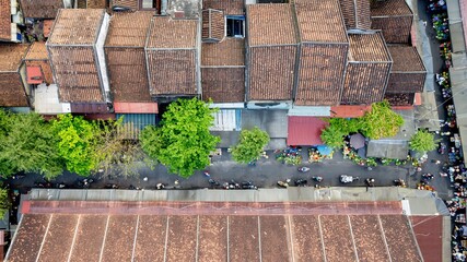 Aerial view of an Asian market with bustling street activities, highlighting urban culture and commerce in a traditional setting