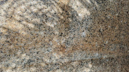 Close-up of a polished granite surface, showcasing natural stone texture, often used in countertops and interior design