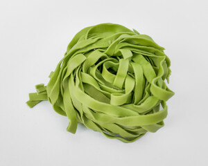 A nest of fresh green spinach fettuccine pasta, ideal for healthy cooking and celebrating Italian cuisine