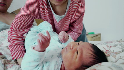 Brother and newborn baby authentic interaction during initial days of life of new member of the...