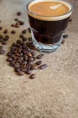 glass cup of espresso coffee with beans