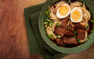 Asian noodles in broth, with beef and egg, top view, close-up, no people,