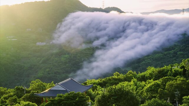 Sky colorful clouds. There is a cloud waterfall on the top of the mountain. View of the mountains surrounding Emerald Reservoir. Xindian District, Taiwan.