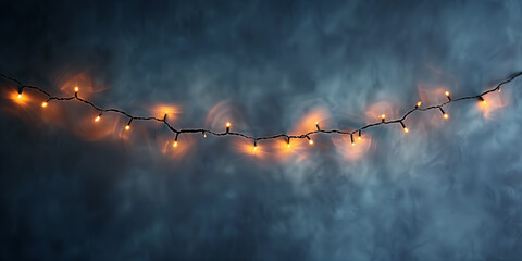  A string of illuminated lights against a dark, smoky background