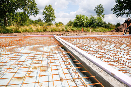 Reinforcing steel wire mesh on the ground of a construction site  - Powered by Adobe