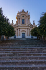 Facade of the beautiful sicilian baroque church Chiesa di San Giovanni Evangelista on a sunny day, Modica, Sicily, Italy