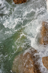 ocean waves crashing on rocky shore