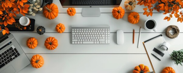Autumn-themed minimalist workspace with pumpkins and office supplies